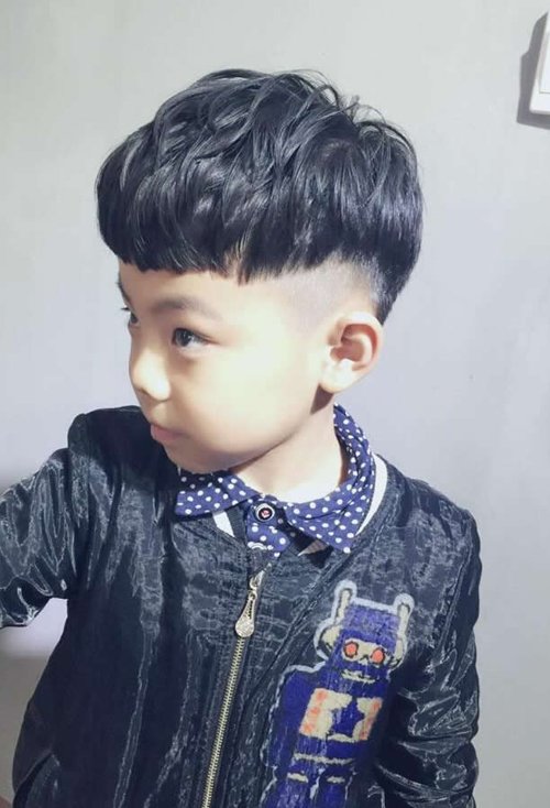 小男孩短头发剪眉上齐刘海造型微卷头发是做着蓬蓬度,鬓角头发部分是